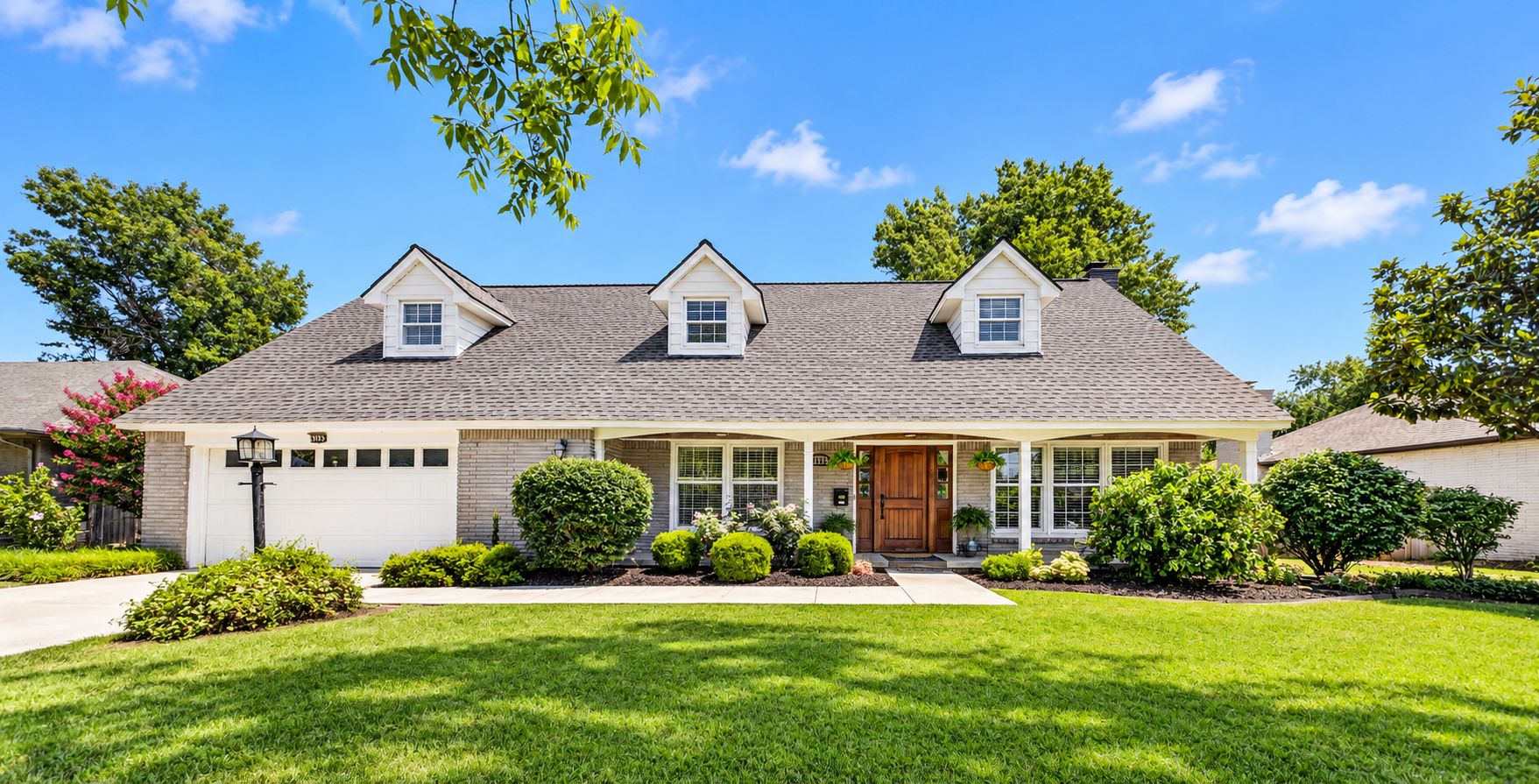 Classic home with dormer windows and landscaped front lawn — Owasso, OK