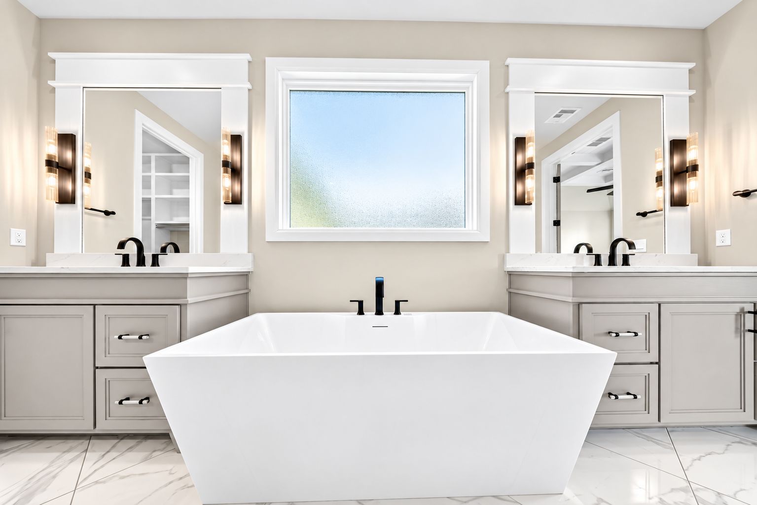 Luxury primary bathroom with a freestanding tub and dual vanities — Owasso, OK